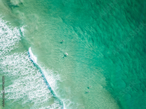 People surfing in pristine blue water