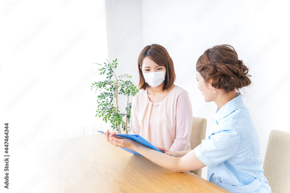 病院で説明を聞く女性 病院で説明を聞く女性