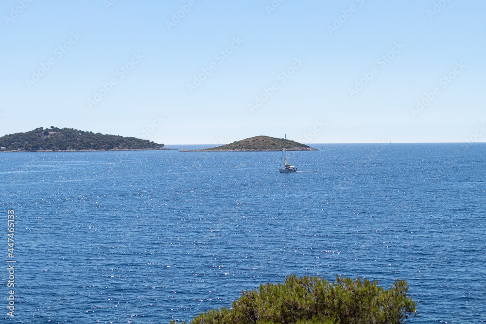 Wonderful view of open sea and islands in archipelago in central Dalmatia from the peninsula of Rogoznica, covered in dense, green pine forest Wonderful view of open sea and islands in archipelago in central Dalmatia from the peninsula of Rogoznica, covered in dense, green pine forest