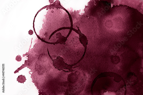 Red wine color background with spots of circles of wine glasses.