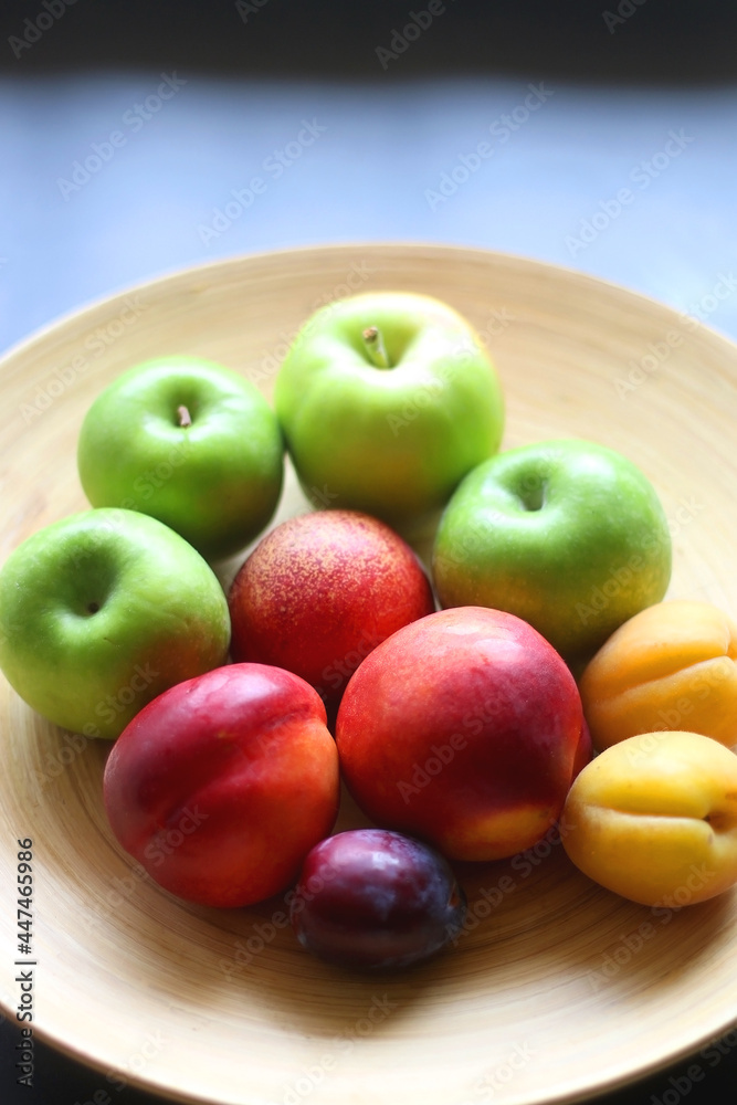 Wooden bowl with various colorful fruit. Selective focus. Wooden bowl with various colorful fruit. Selective focus.