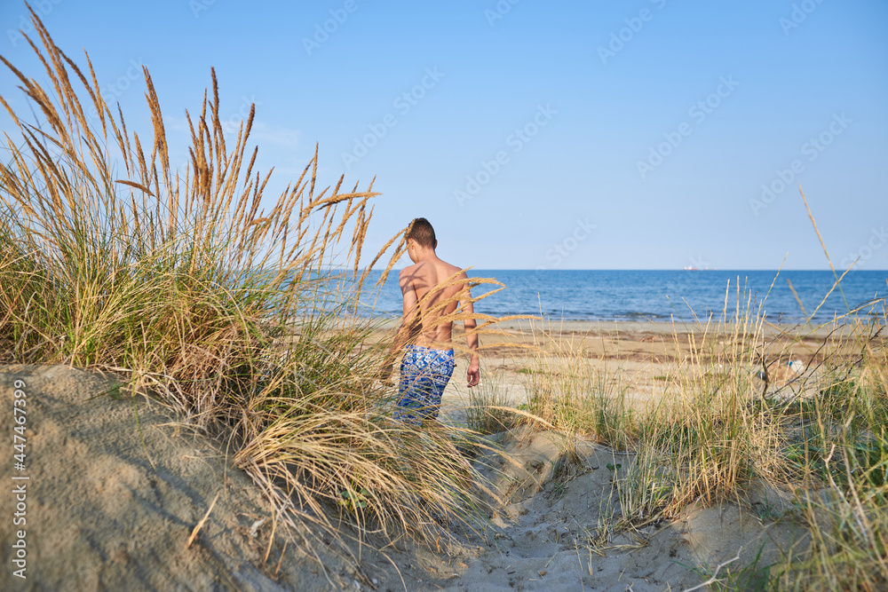 Traveler boy on beach in vacation.