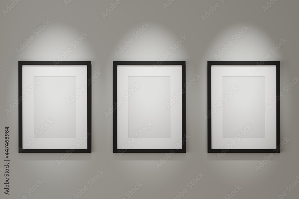 Three black picture frame mock up on the wall with lighting. 3d rendering. Three black picture frame mock up on the wall with lighting. 3d rendering.