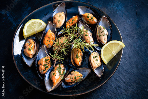 Steamed mussels with herbs and lemon. Tapas plate with mussels. Food photography
