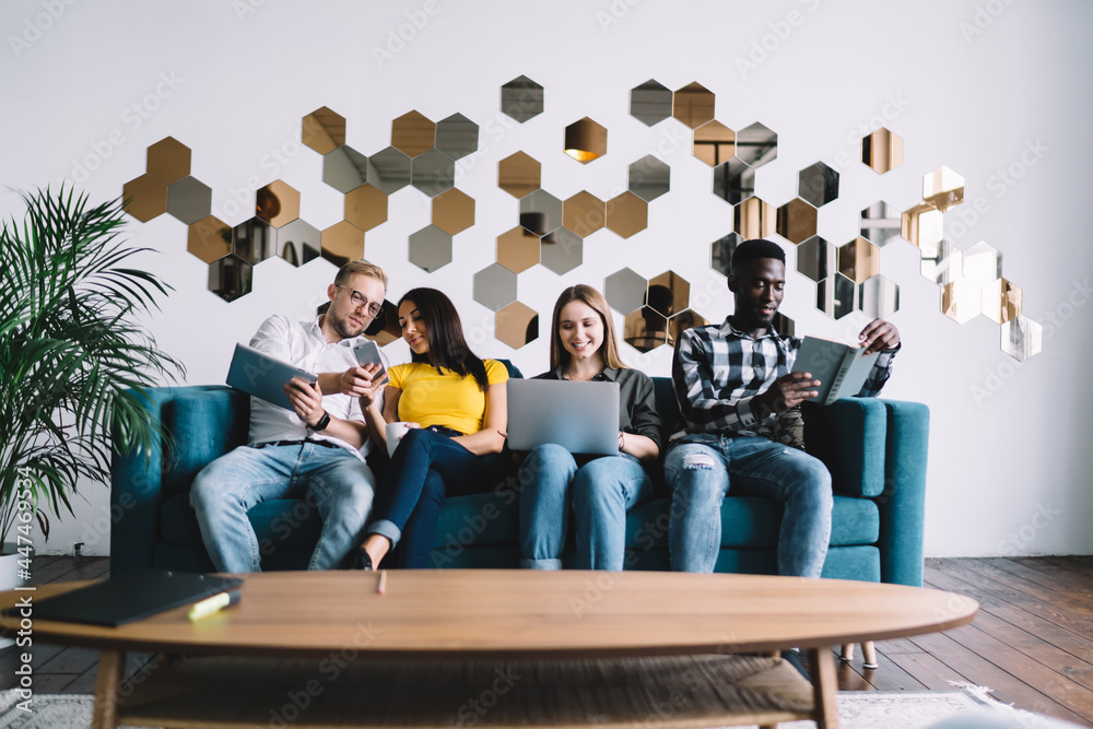 Fototapeta premium Multiethnic people chilling together on couch