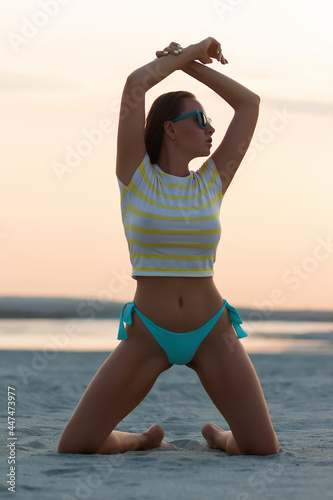 Bild auf Leinwand Sexy woman in t shirt sitting on beach