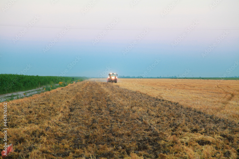 Obraz premium tractor plows the field