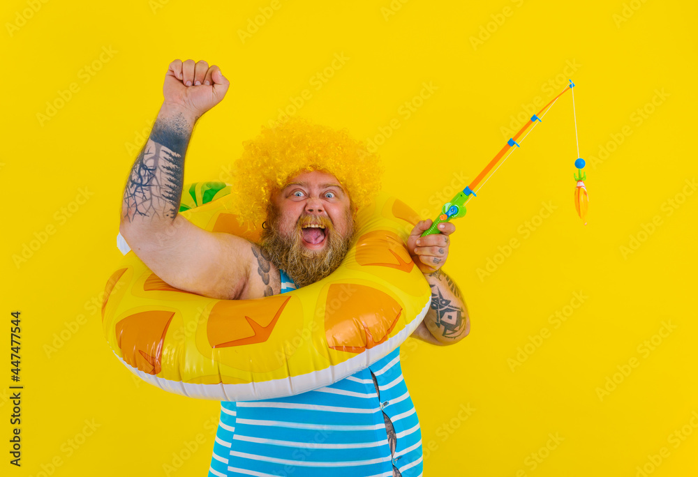 Fat happy man with wig in head plays with the fishing rod Fat happy man with wig in head plays with the fishing rod