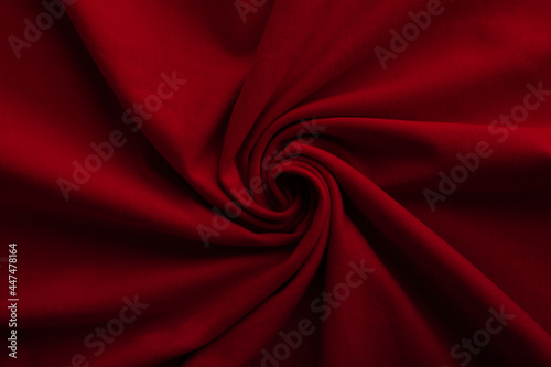 Texture of knitted red fabric. Red cotton background. Red fiber surface. Canvas backdrop.