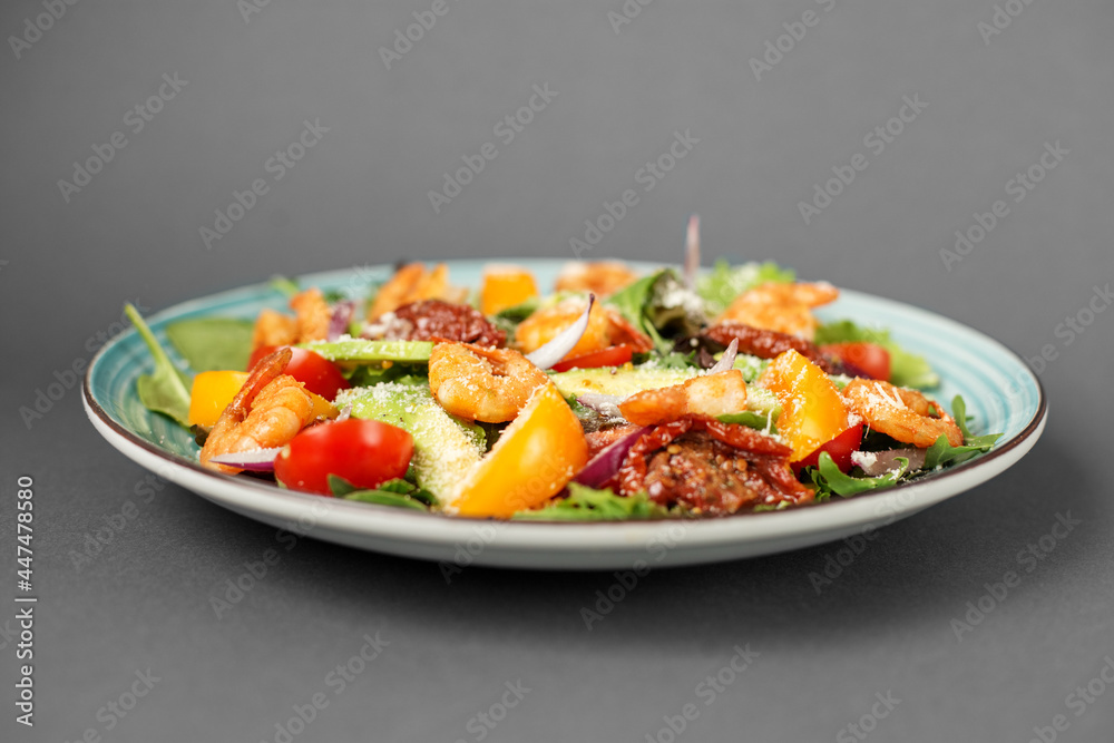 Fresh salad plate with shrimp, tomato and mixed greens (arugula, mesclun, mache) on wooden background close up. Healthy food. Clean eating. Fresh salad plate with shrimp, tomato and mixed greens (arugula, mesclun, mache) on wooden background close up. Healthy food. Clean eating.