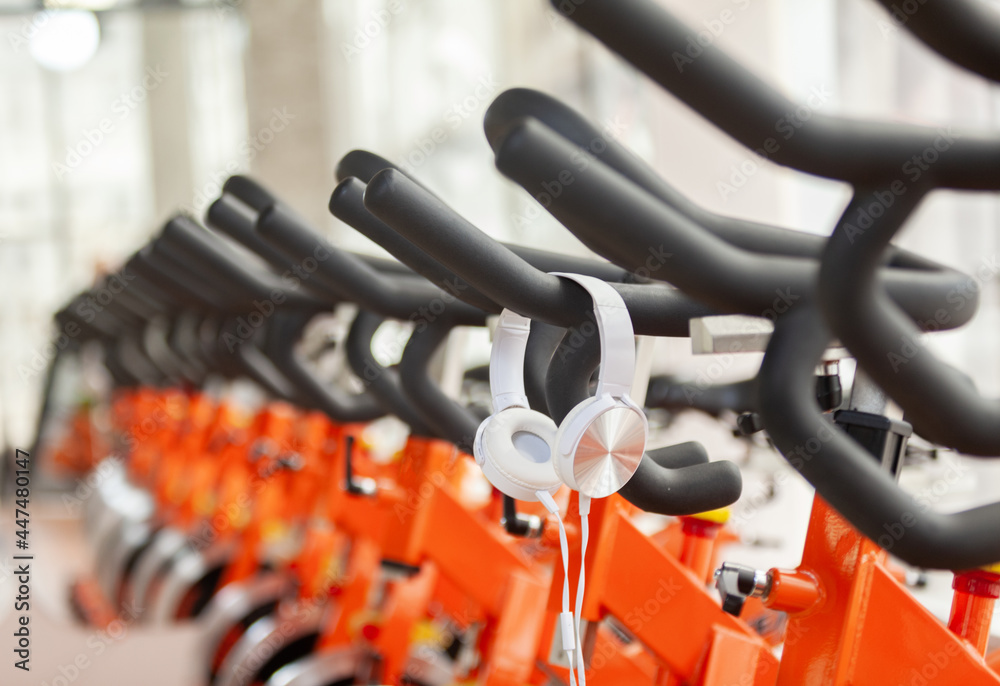 Healthy lifestyle concept. Spinning class with empty bicycles and headphones. Fitness, sports, workout Healthy lifestyle concept. Spinning class with empty bicycles and headphones. Fitness, sports, workout