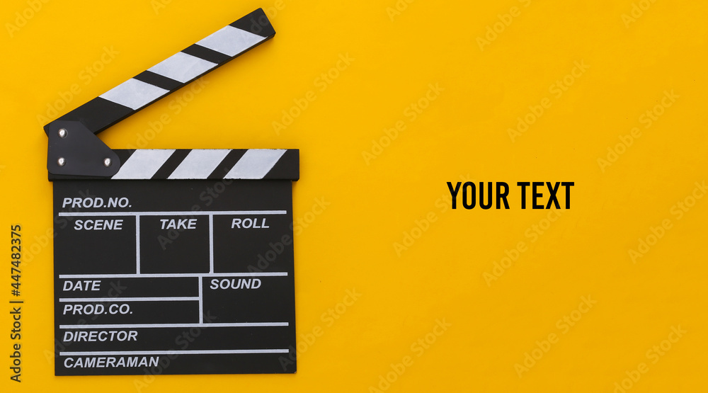 Movie clapper board on yellow background. Filmmaking, Movie production, Entertainment industry. Copy space. Top view