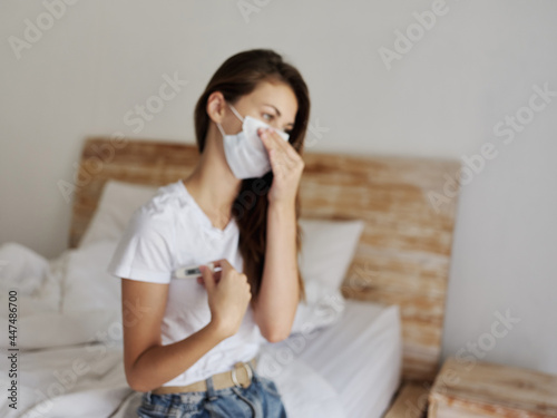 woman wearing medical mask temperature health check