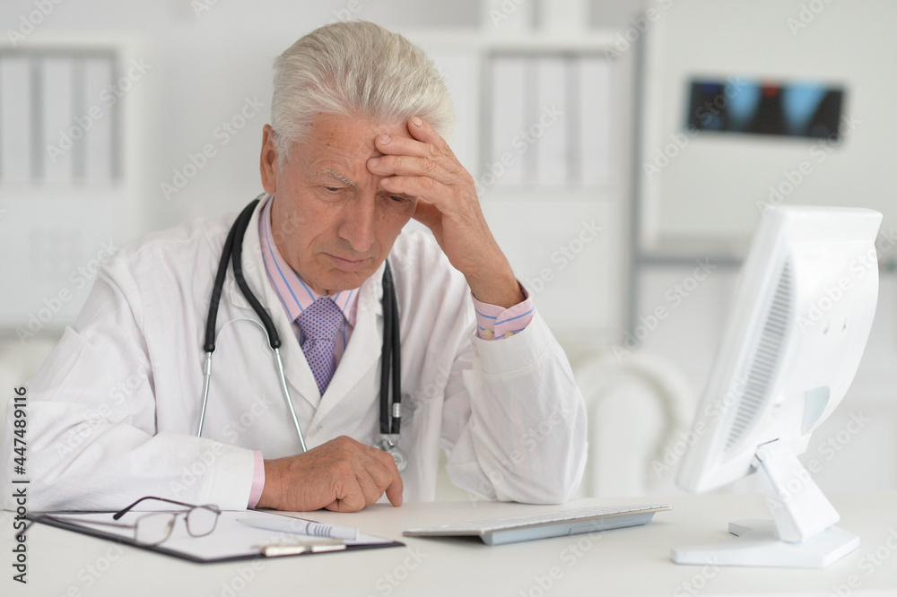 portrait of confident senior male doctor with stethoscope working in office portrait of confident senior male doctor with stethoscope working in office