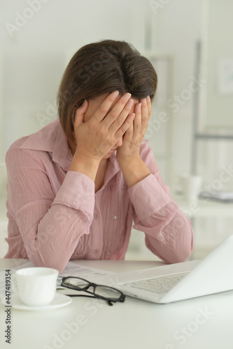 young woman with laptop in the office