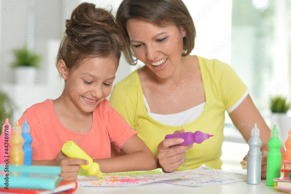 Cute girl with mother drawing at home Cute girl with mother drawing at home