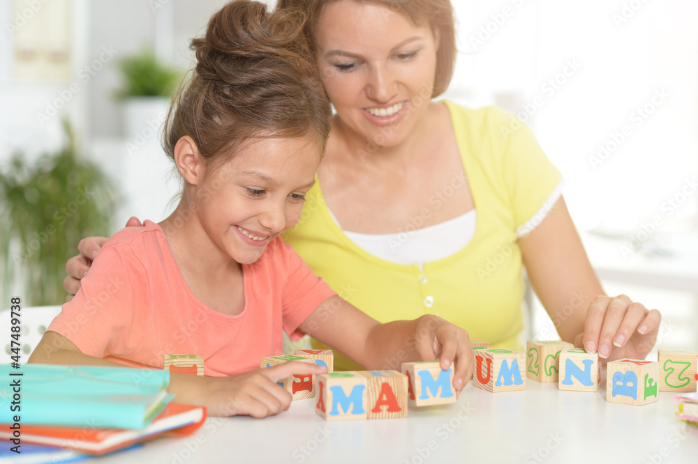 Portrait of mother and granddaughter with cubes Portrait of mother and granddaughter with cubes