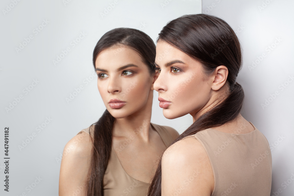 Anxious woman and self-image mirror on white background Anxious woman and self-image mirror on white background