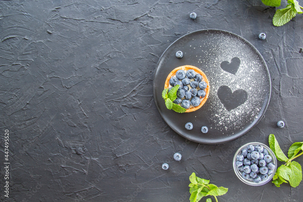 A healthy tasty dessert of cheese blueberry tart. Creative atmospheric decoration A healthy tasty dessert of cheese blueberry tart. Creative atmospheric decoration