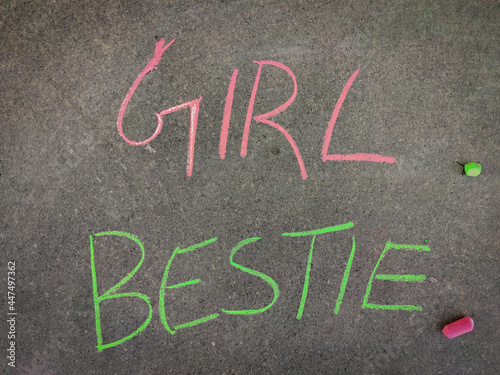 The inscription text on the grey board, girl Bestie. Using color chalk pieces.