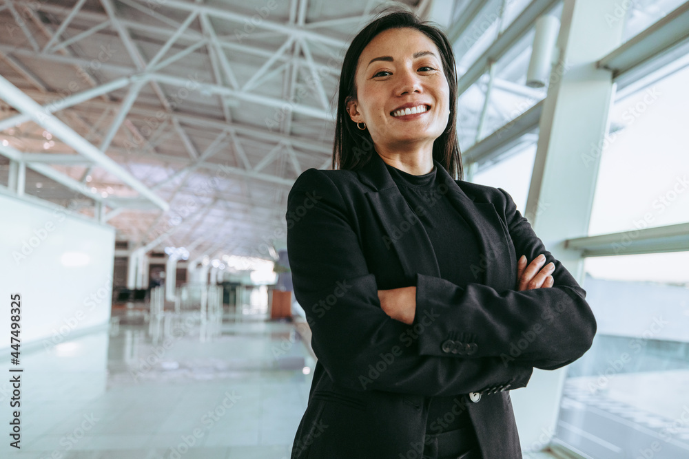 Smiling woman waiting at airport terminal Smiling woman waiting at airport terminal