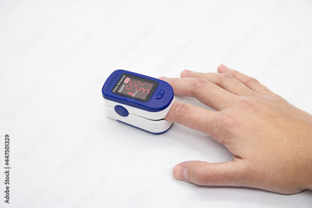 Hand using oximeter on index finger Hand using oximeter on index finger