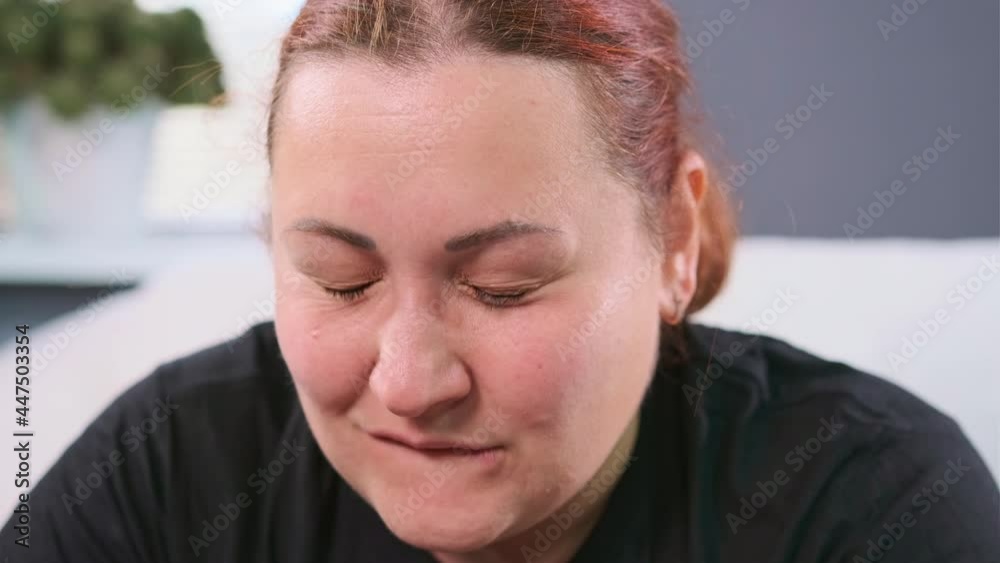 Close up video of a woman carrying information through herself, empathizes to it grabs her head and lately calm down. Close up video of a woman carrying information through herself, empathizes to it grabs her head and lately calm down.