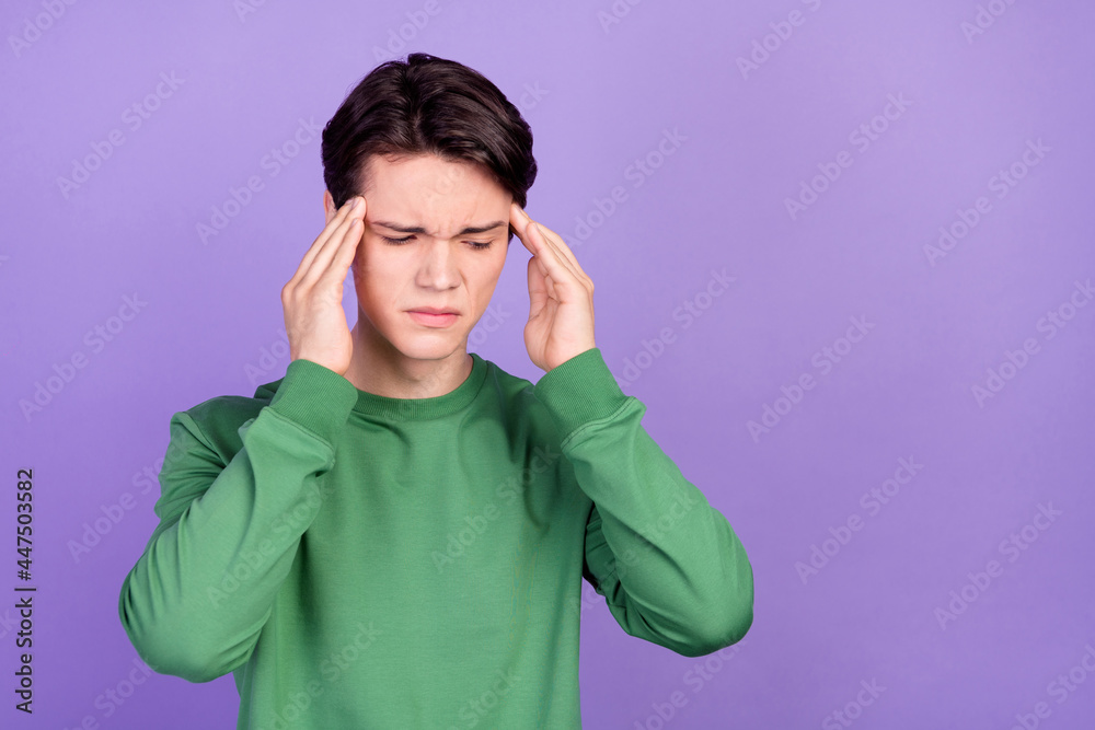 Photo of young man hands touch head unhealty symptom flu headache isolated over purple color background Photo of young man hands touch head unhealty symptom flu headache isolated over purple color background