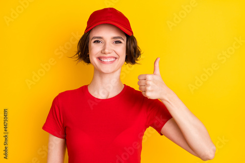 Photo of nice optimistic brown hair lady thumb up wear t-shirt isolated on yellow color background photo