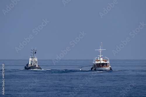 Obraz na plátně tugboat towing small boat ship
