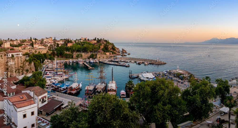 Ships in the old harbour in Antalya (Kaleici), Turkey. Old town of Antalya is a popular Tourist destination in Turkey. Travel background.