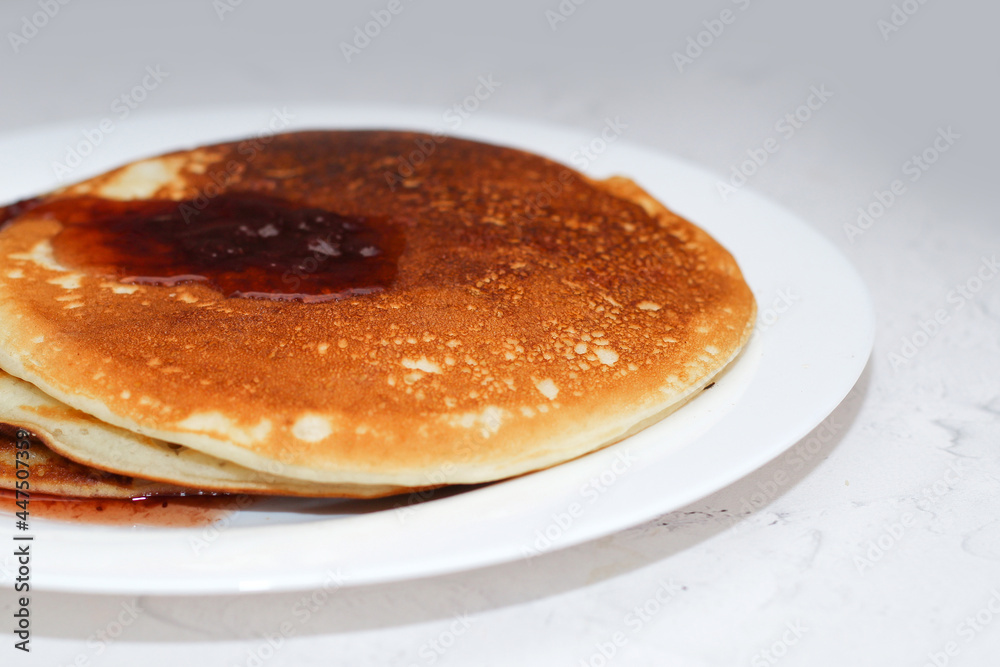 Pancakes in a snow-white plate. Rosy hot sweet breakfast. Pancakes in a snow-white plate. Rosy hot sweet breakfast.