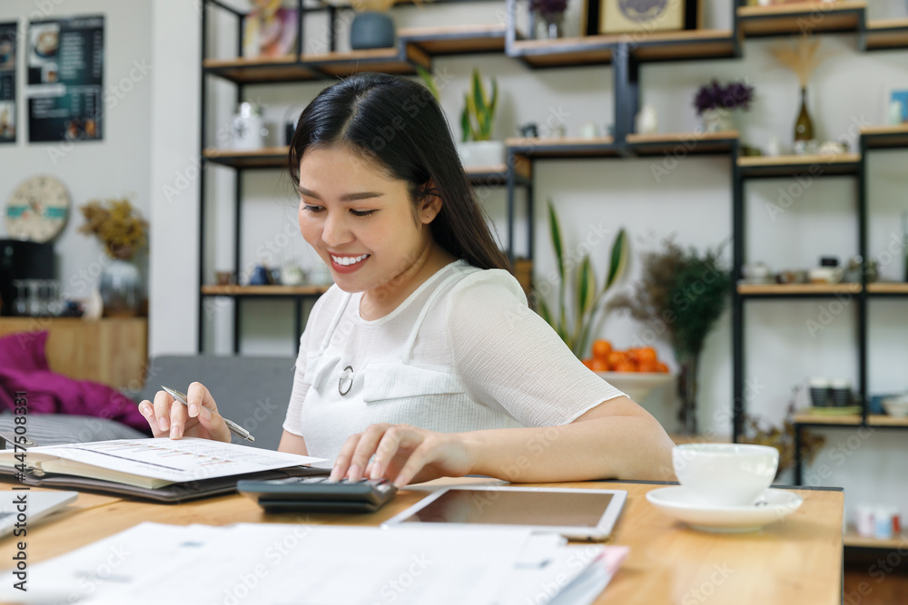 Young asian woman in smart casual wear working in home office. Social distance practice prevent coronavirus COVID-19. Young asian woman in smart casual wear working in home office. Social distance practice prevent coronavirus COVID-19.