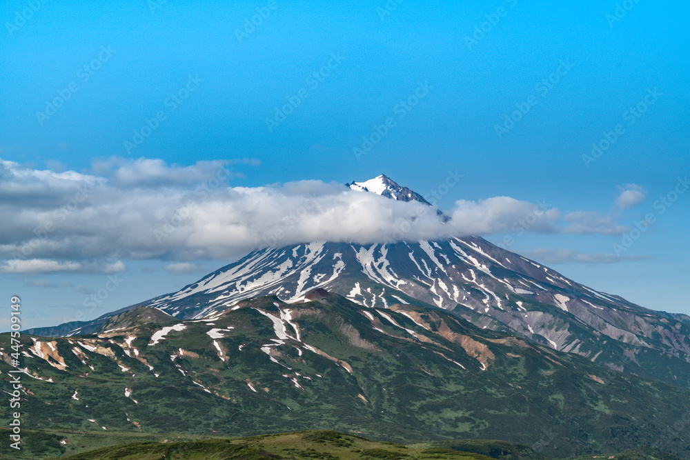 Russia, Kamchatka. Beautiful view of the Vilyuchinsky volcano in clouds.