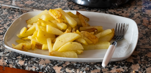 French fries on dish with a fork