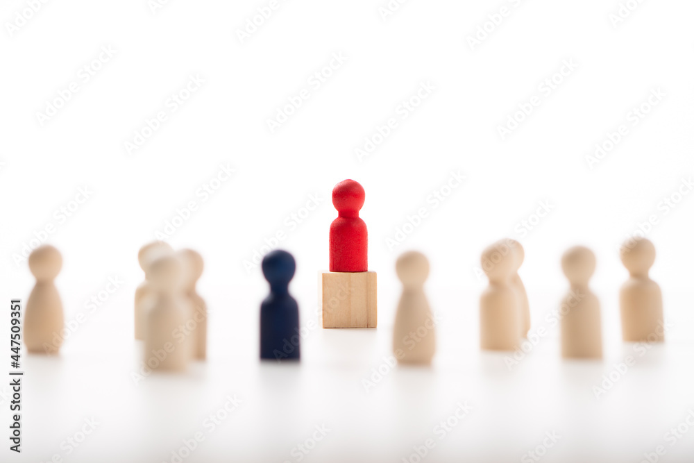 The red wooden figure standing on the box show influence and empowerment. Concept of business leadership for leader team, successful competition winner and Leader with influence The red wooden figure standing on the box show influence and empowerment. Concept of business leadership for leader team, successful competition winner and Leader with influence