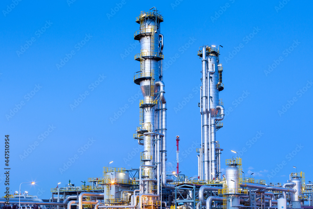 View of a gas refinery plant illuminated at dusk. View of a gas refinery plant illuminated at dusk.