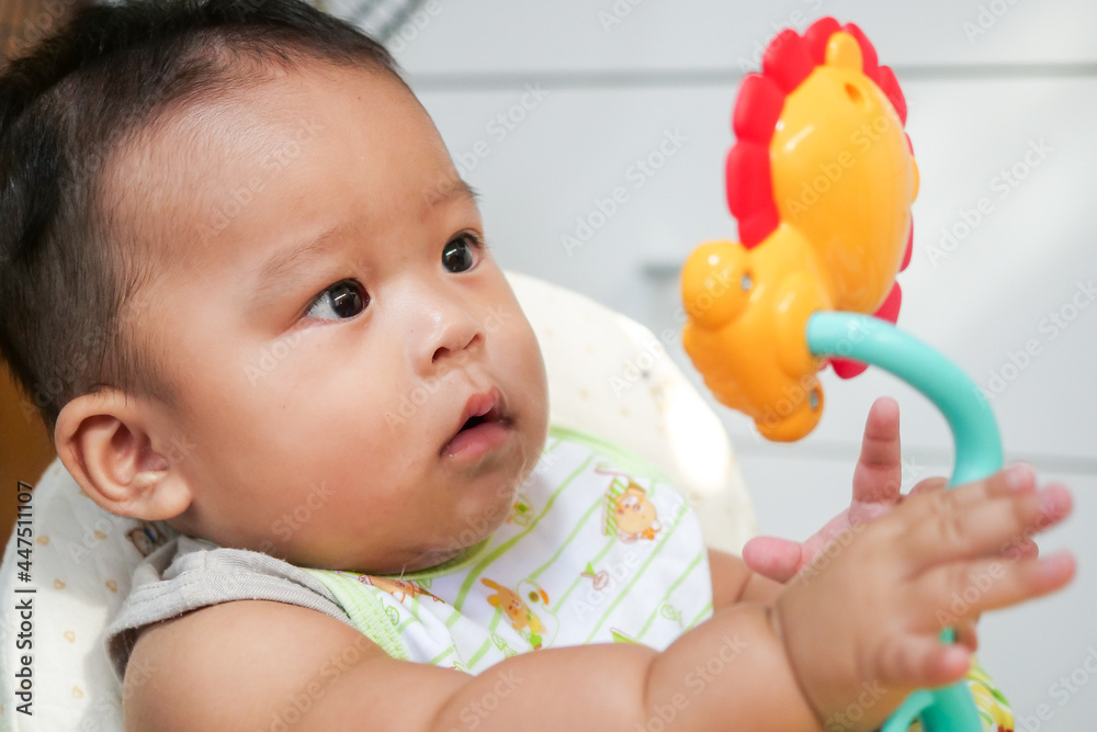 Asian little baby playing with colorful toys at home Asian little baby playing with colorful toys at home