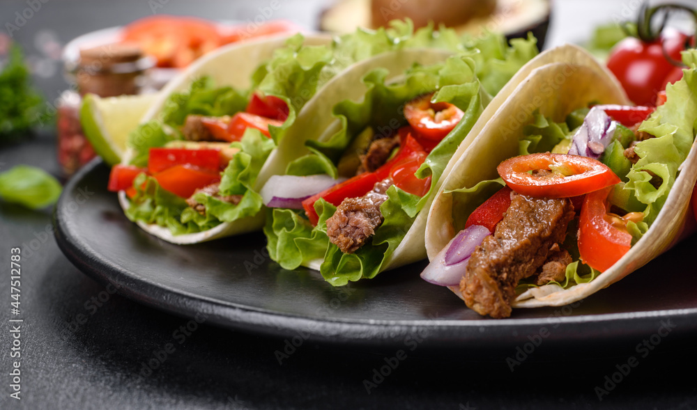 Mexican tacos with beef, tomatoes, avocado, onion and salsa sauce Mexican tacos with beef, tomatoes, avocado, onion and salsa sauce
