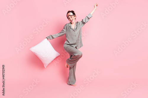 Full length body size view of attractive cheerful girl wearing pajama dancing having fun isolated over pink pastel color background