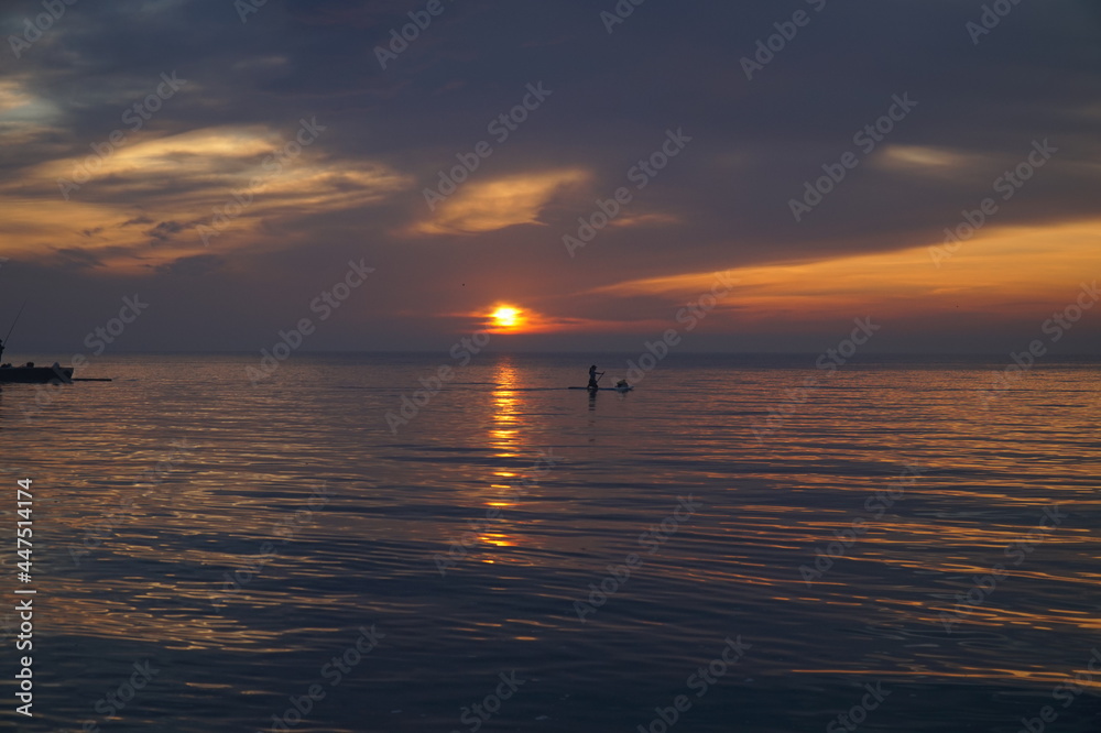 Dawn over the Black Sea and a man on a kayak who meets him.