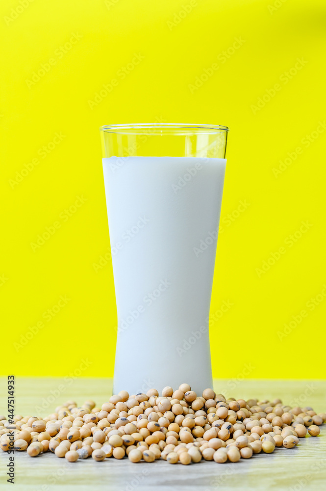 soybean milk in glass isolated on yellow background, health care concept soybean milk in glass isolated on yellow background, health care concept