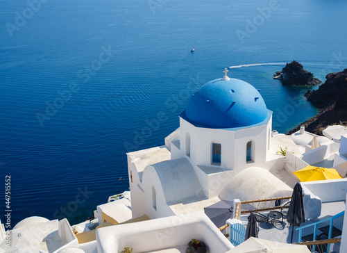 Oia village, Santorini Island, Greece. View of traditional houses and church in Santorini. Travel and vacation photography.