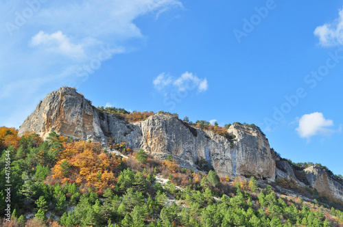 Breathtaking view of rocks covered with bright colourful autumn forest.