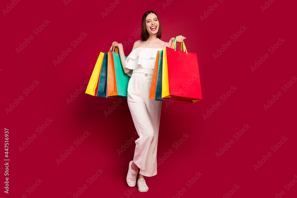 Full body photo of cool brown hairdo millennial lady with bags wear top pants isolated on red background Full body photo of cool brown hairdo millennial lady with bags wear top pants isolated on red background