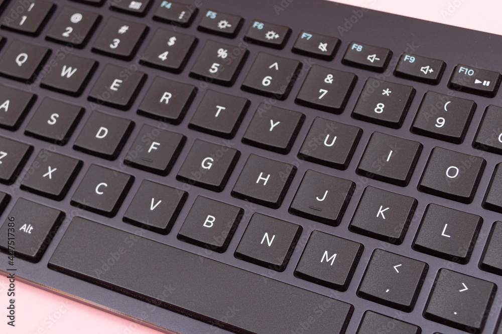 Black Bluetooth Keyboard for Tablet or PC on Pink Background