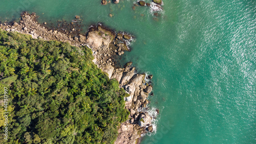 Aerial view of waves hitting rocks on a Brazilian beach coast. Balneario Camboriu photo