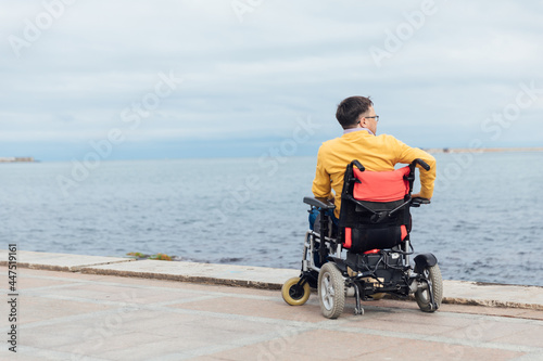 Wallpaper Mural a man with disabilities in a wheelchair enjoys life Torontodigital.ca