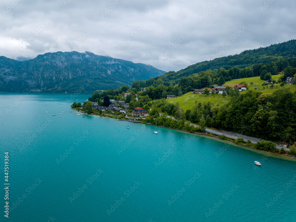 Aerial view of the small village on lake Attersee at cloudy morning.
