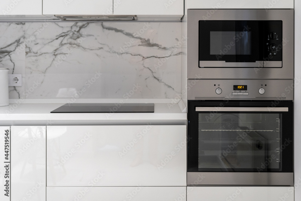 Obraz premium Kitchen counter with electrical plate, oven and microwave